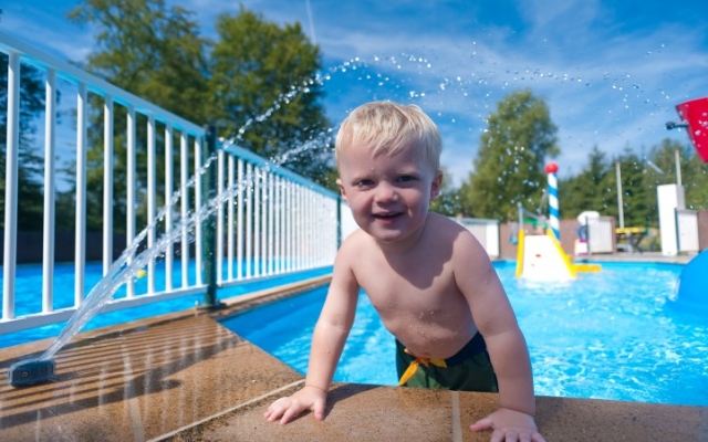 Kind zwemt in het zwembad van onze camping op de Veluwe